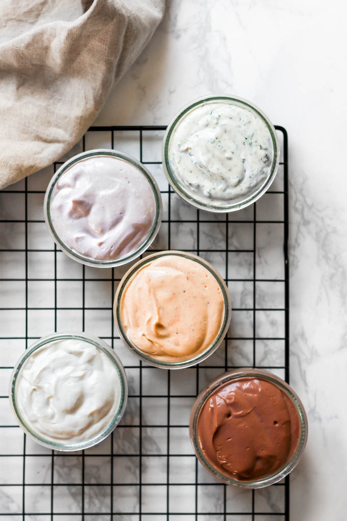 a collection of 5 different flavors of homemade vegan cream cheese