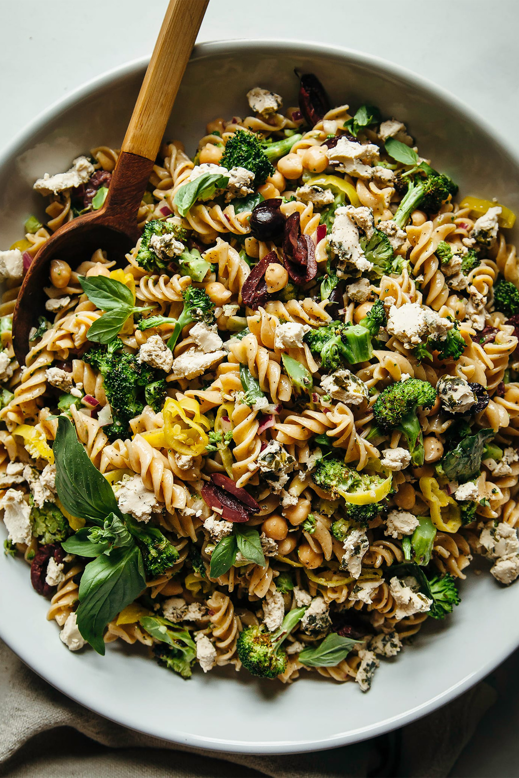 a bowl of vegan pasta salad with grilled vegetables