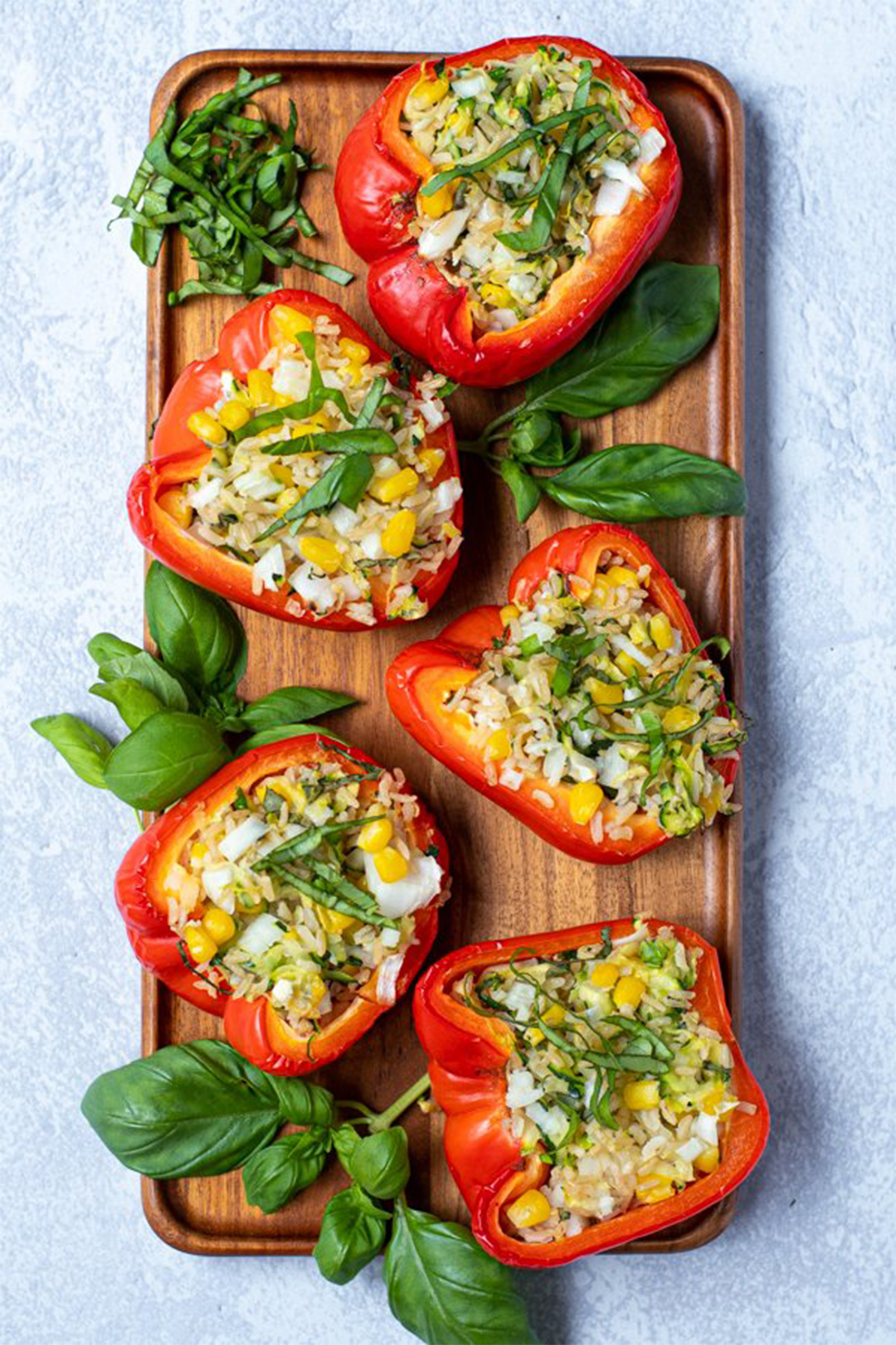 a board of grilled stuffed red bell peppers