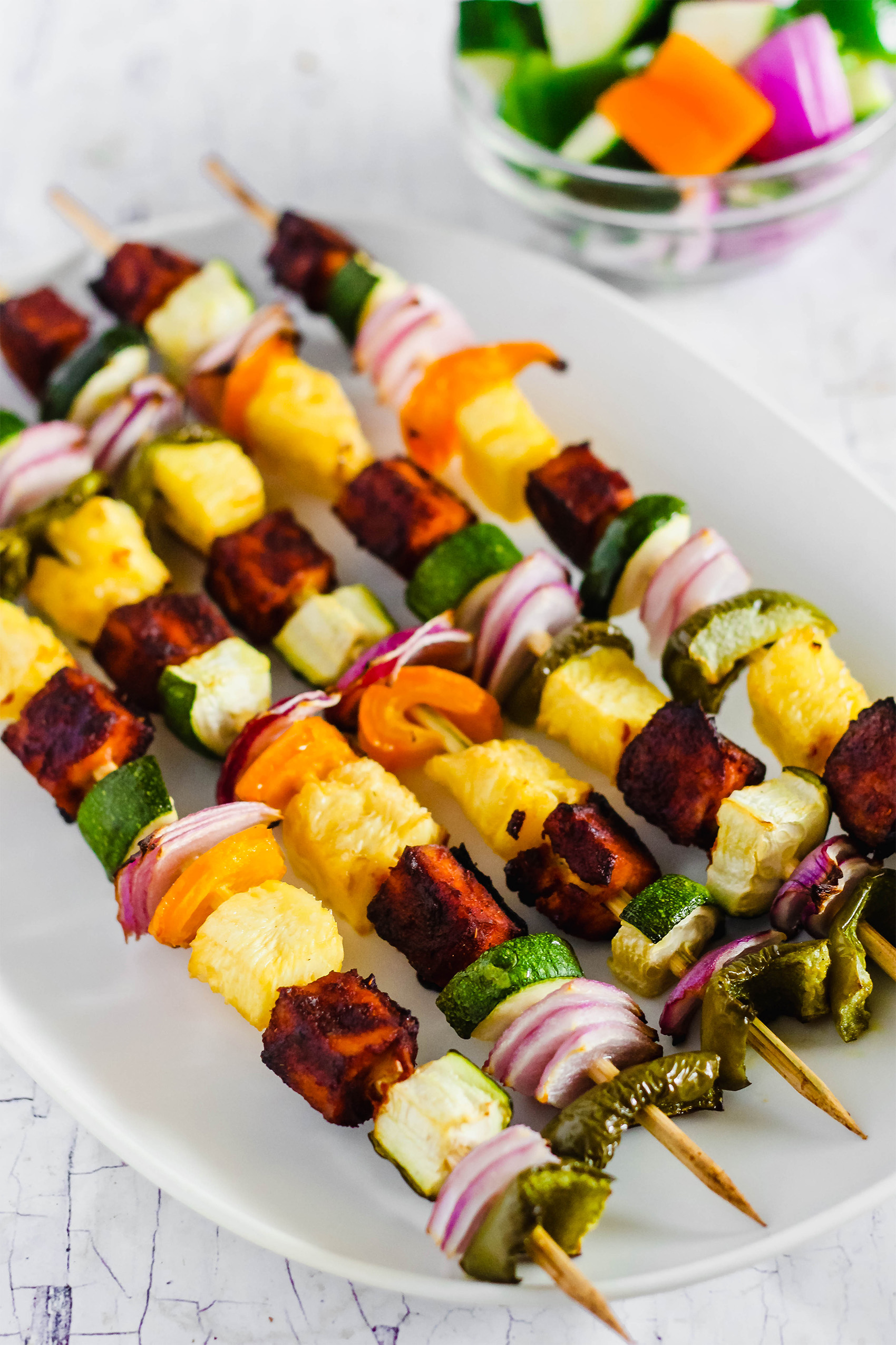 a plate of vegan tofu vegetable skewers