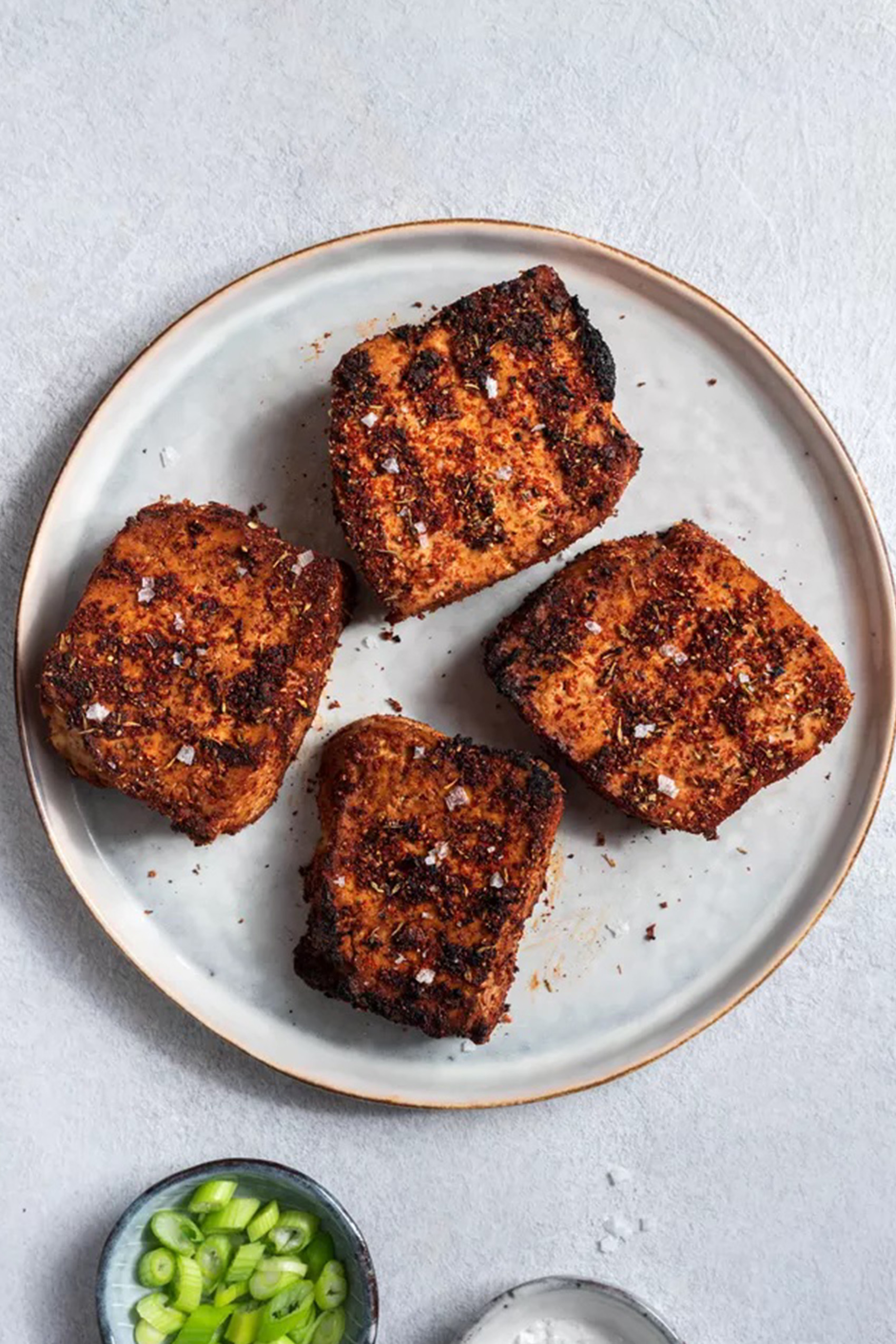 a plate of blackened grilled tofu slices