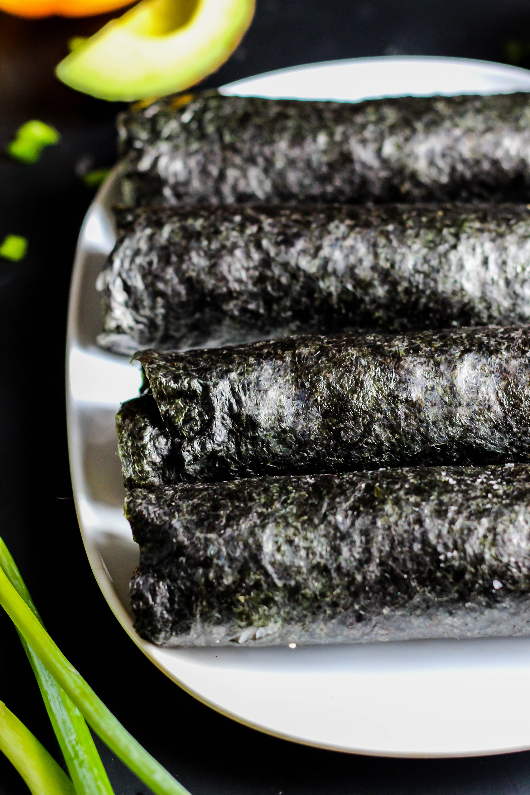 a plate of sushi rolls before they have been cut