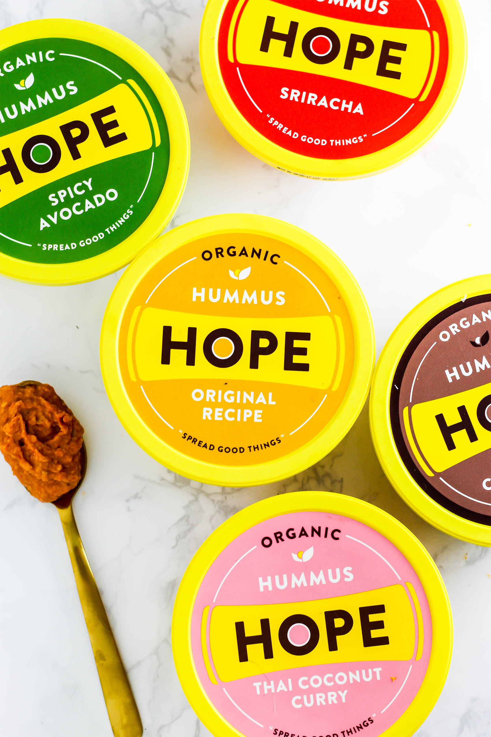 a collection of five different flavors of Hope hummus including original, chocolate, sriracha, thai curry and spicy avocado