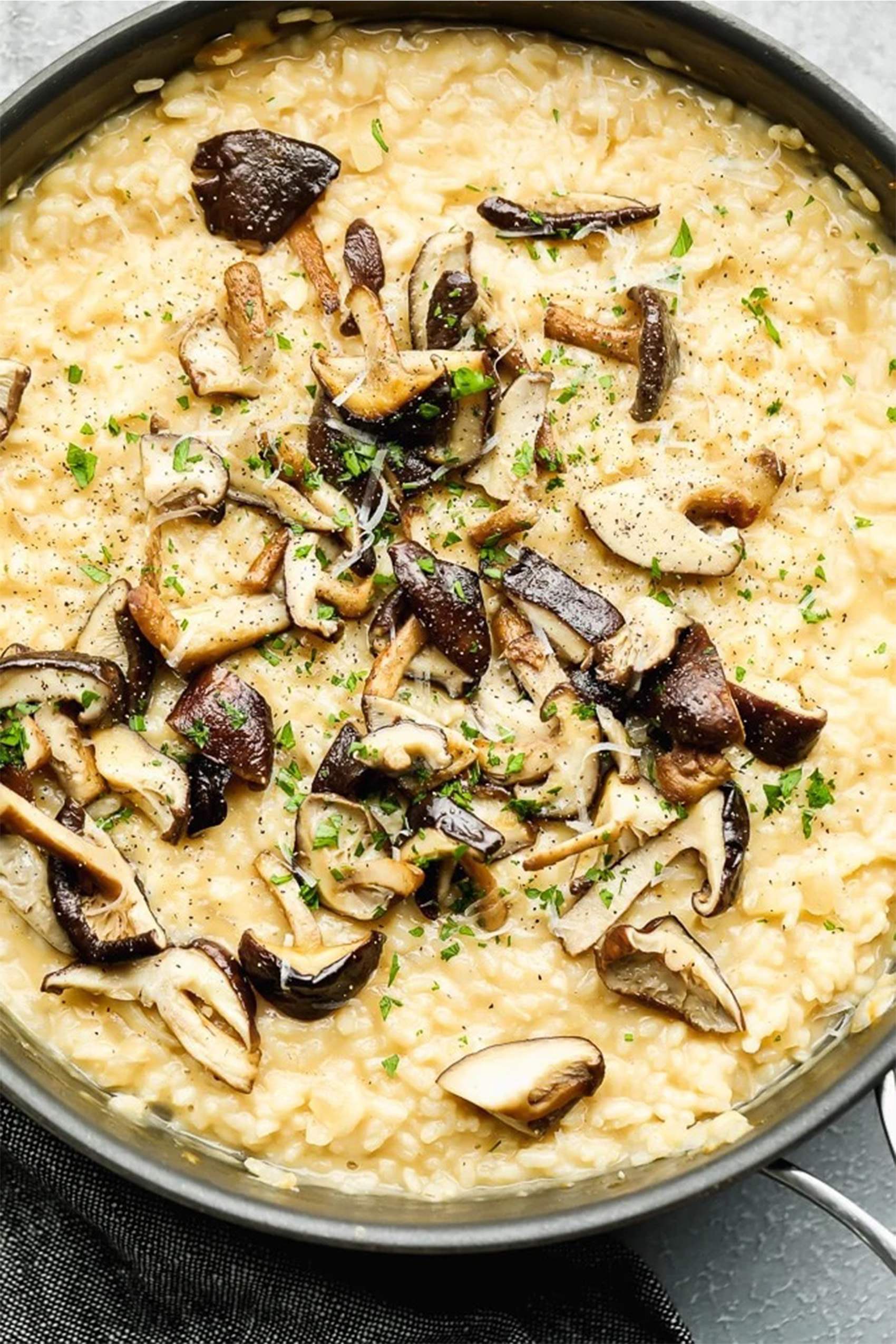 a pot of creamy vegan risotto topped with mushrooms