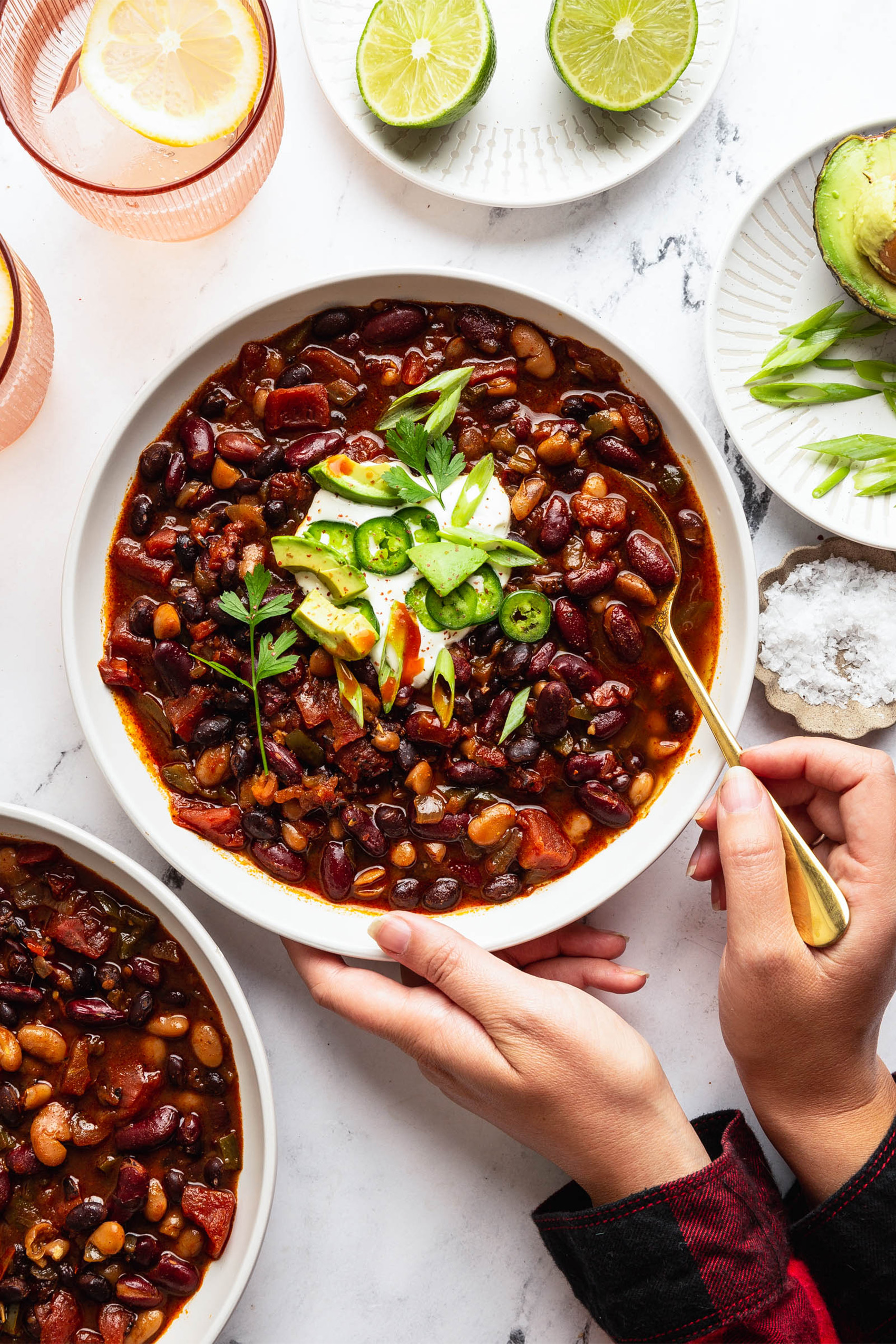 a bowl of pinto bean soup garnished with herbs