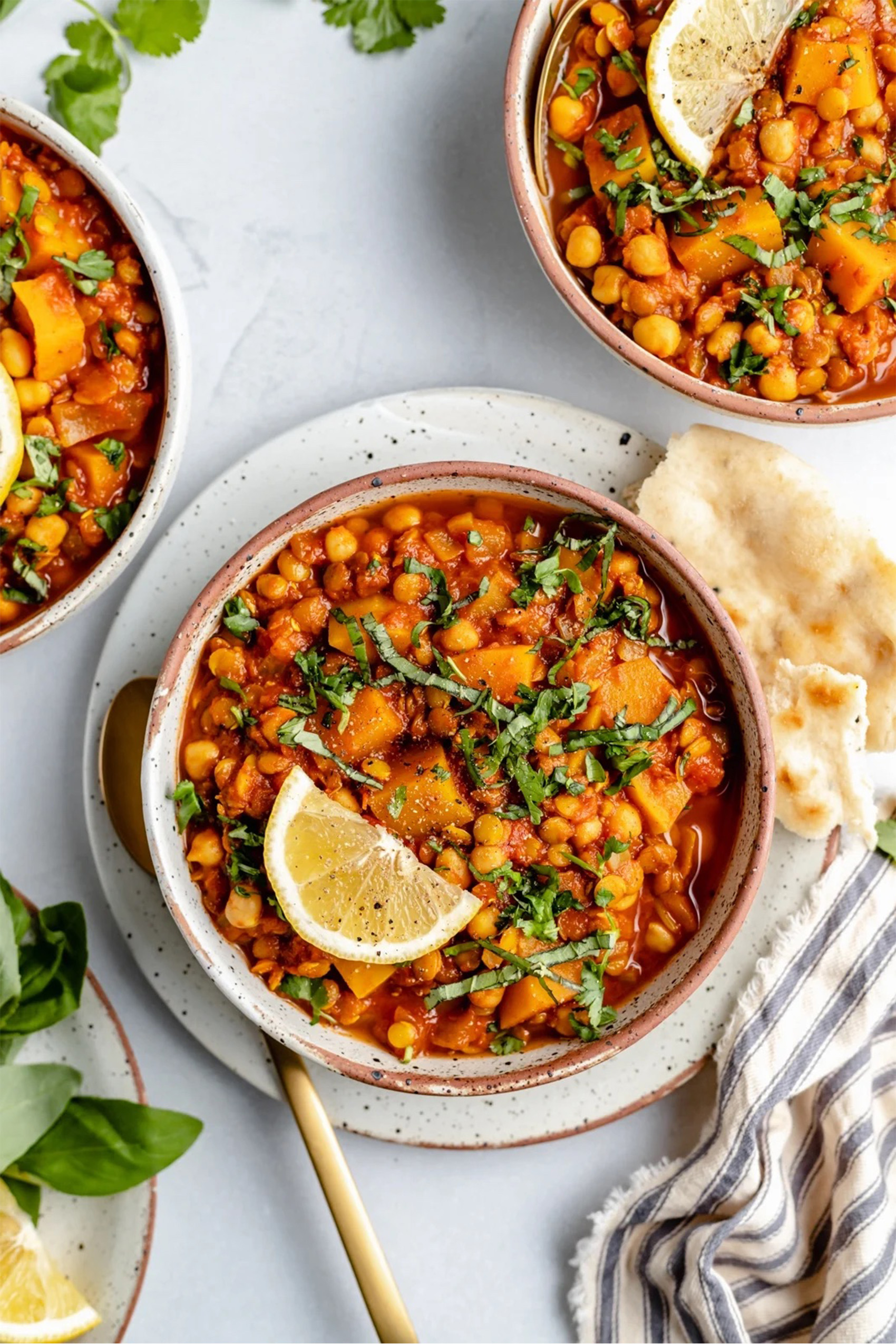 three bowls of vegan butternut squash chickpea stew