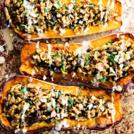 a sheet tray of stuffed butternut squash halves