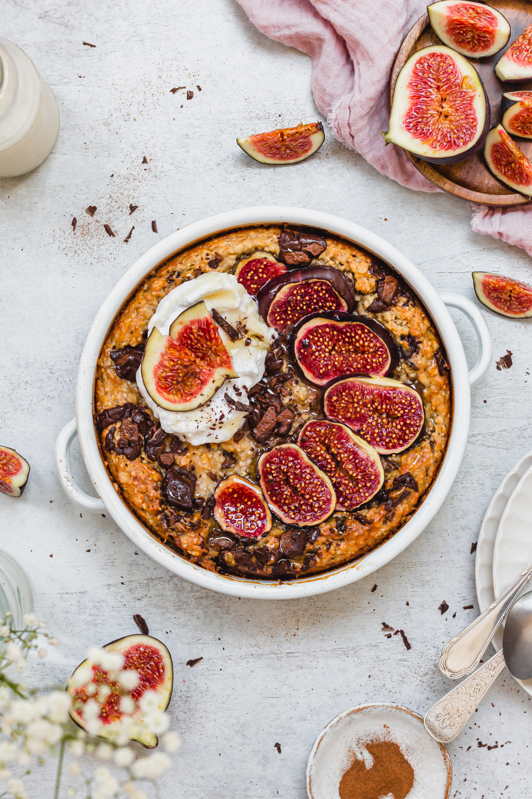 a dish filled with chocolate chip baked oats topped with sliced figs