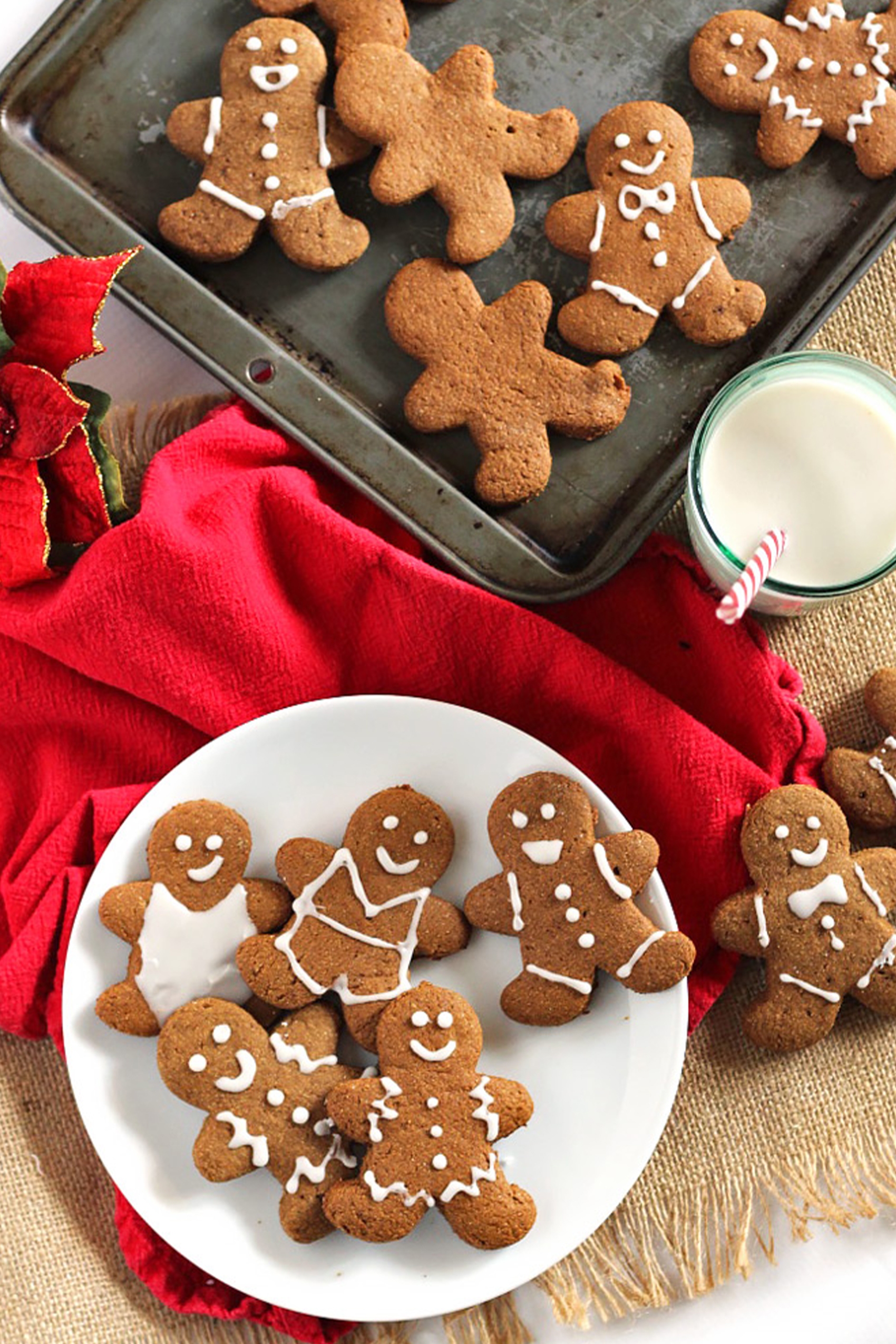 a plate of vegan gingerbread cookies decorated with white icing
